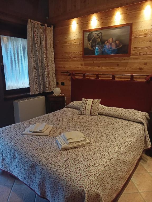 Letto o letti in una camera di L'Alpina Affittacamere