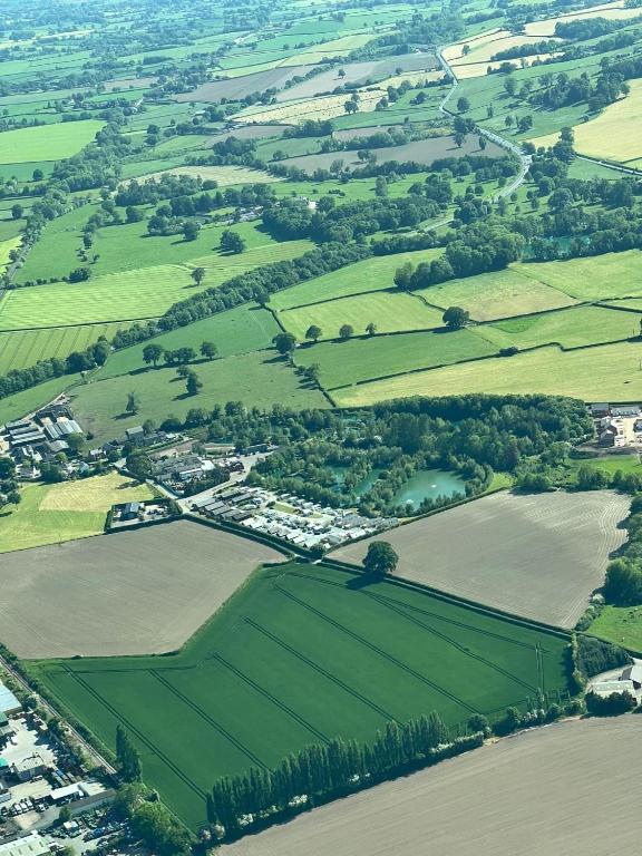 an aerial view of a village in the middle of a field at Weston glamping pod in Oswestry