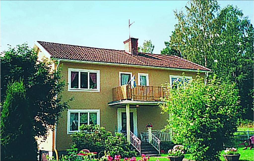 a large house with a deck and a balcony at Hällgården in Vena