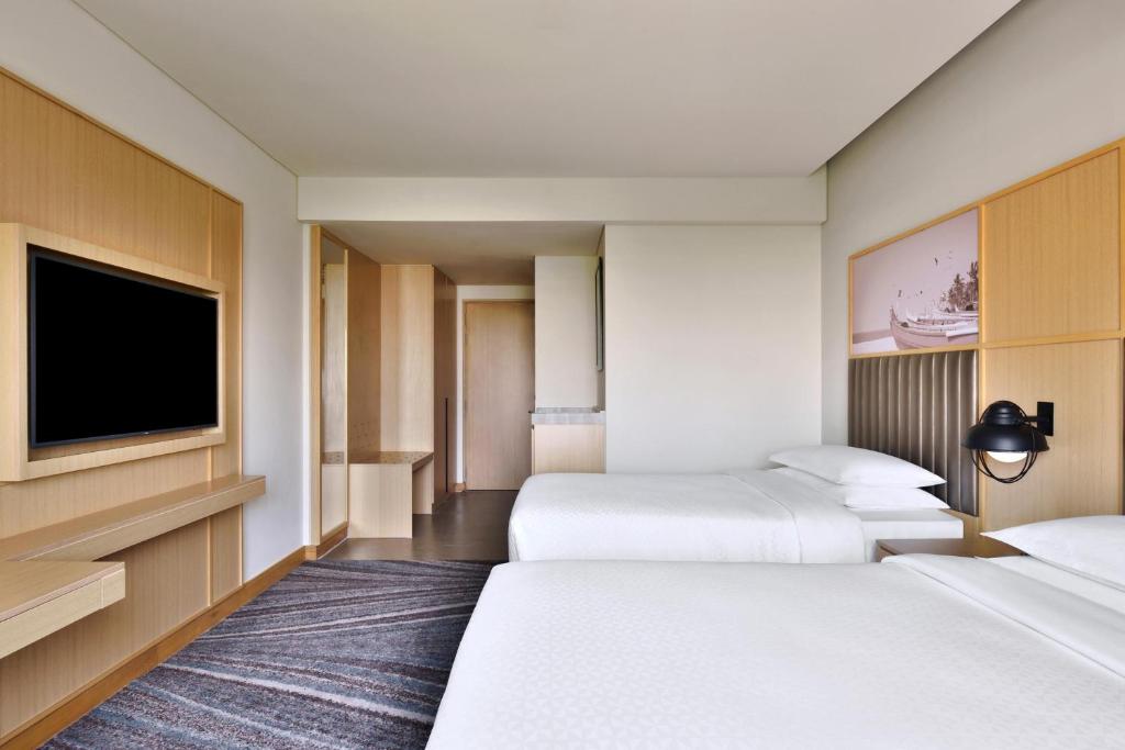 Postel nebo postele na pokoji v ubytování Four Points by Sheraton Kochi Infopark