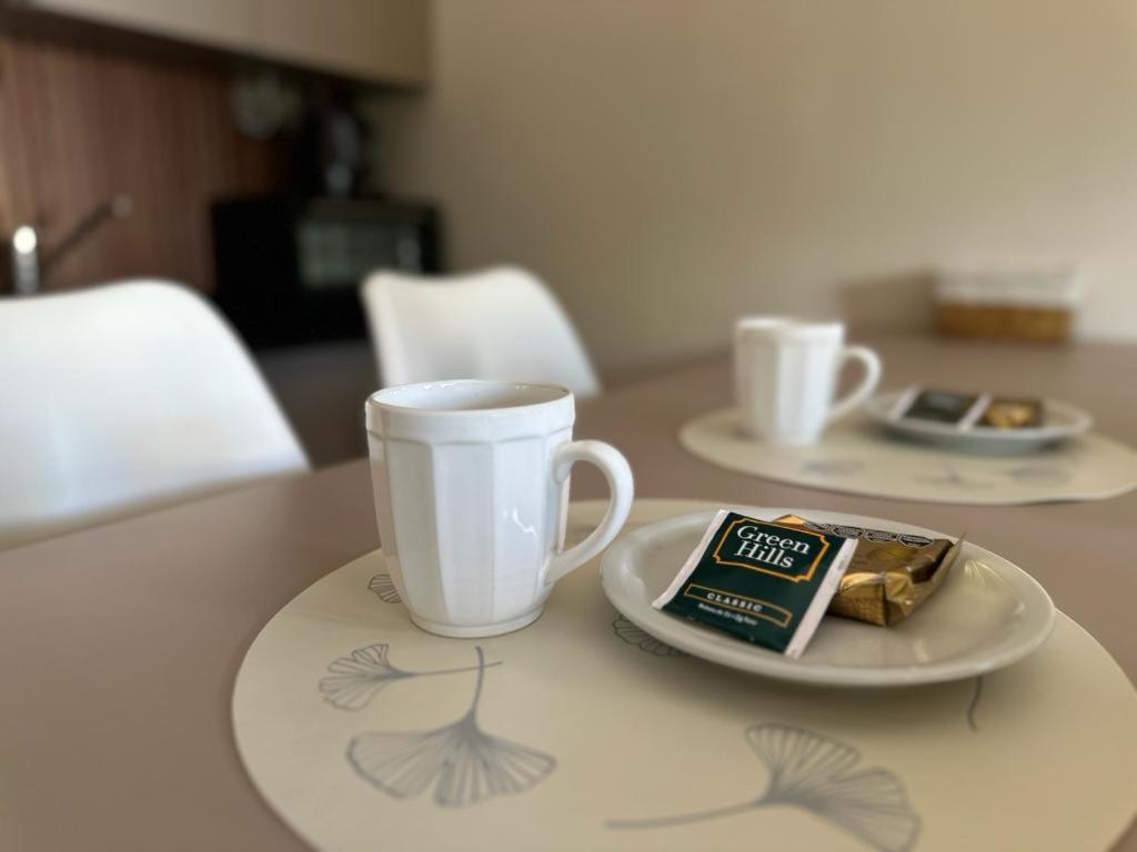 a table with a cup and a plate with a snack at Departamento en San Luis in San Luis
