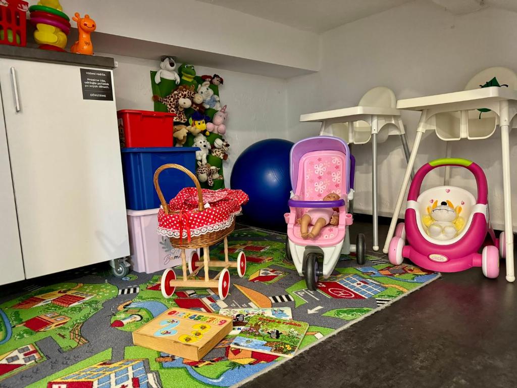 a childs play area with toys on the floor at Hotel Vincent in Luhačovice