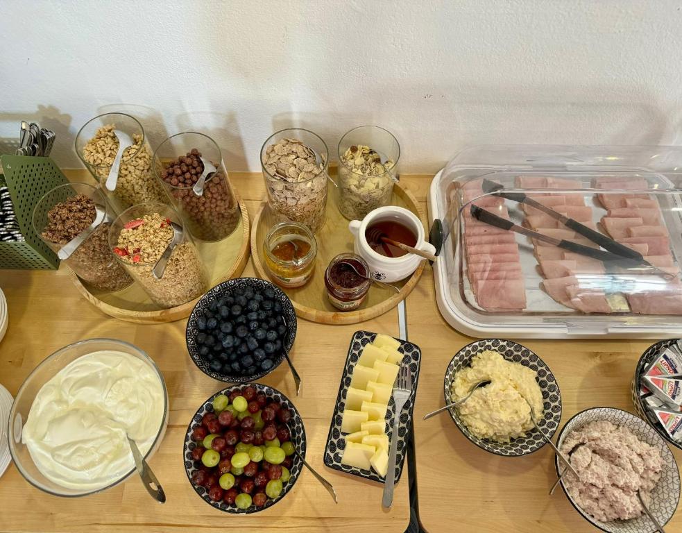 a table topped with different types of food and desserts at Hotel Vincent in Luhačovice