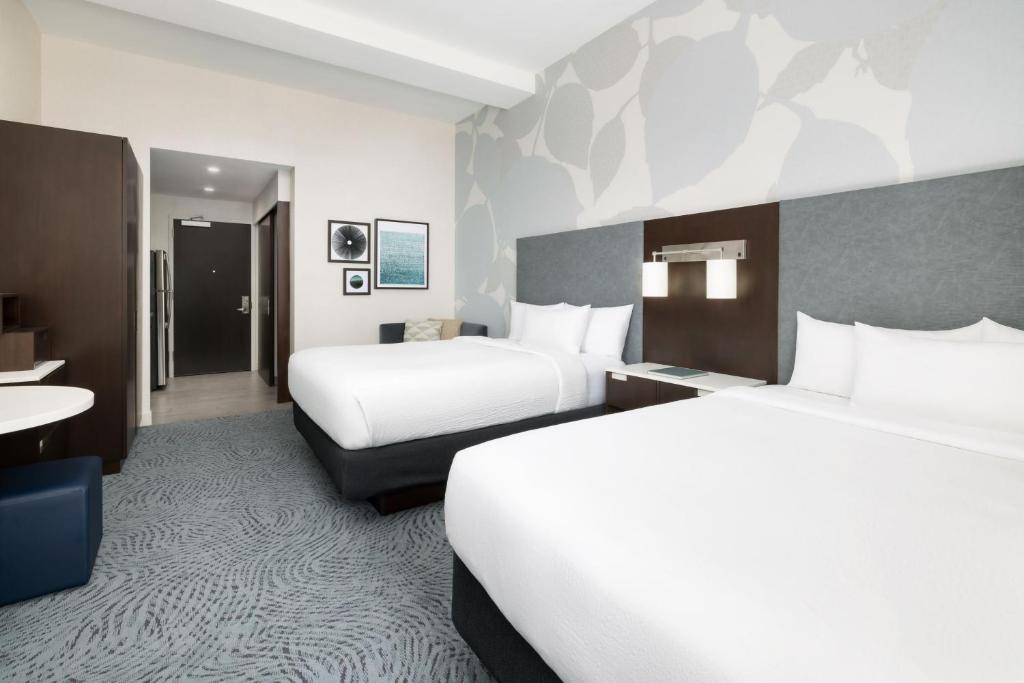 a hotel room with two beds and a desk at Residence Inn by Marriott New York Downtown Manhattan/World Trade Center Area in New York