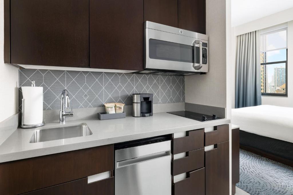 a kitchen with a sink and a microwave at Residence Inn by Marriott New York Downtown Manhattan/World Trade Center Area in New York