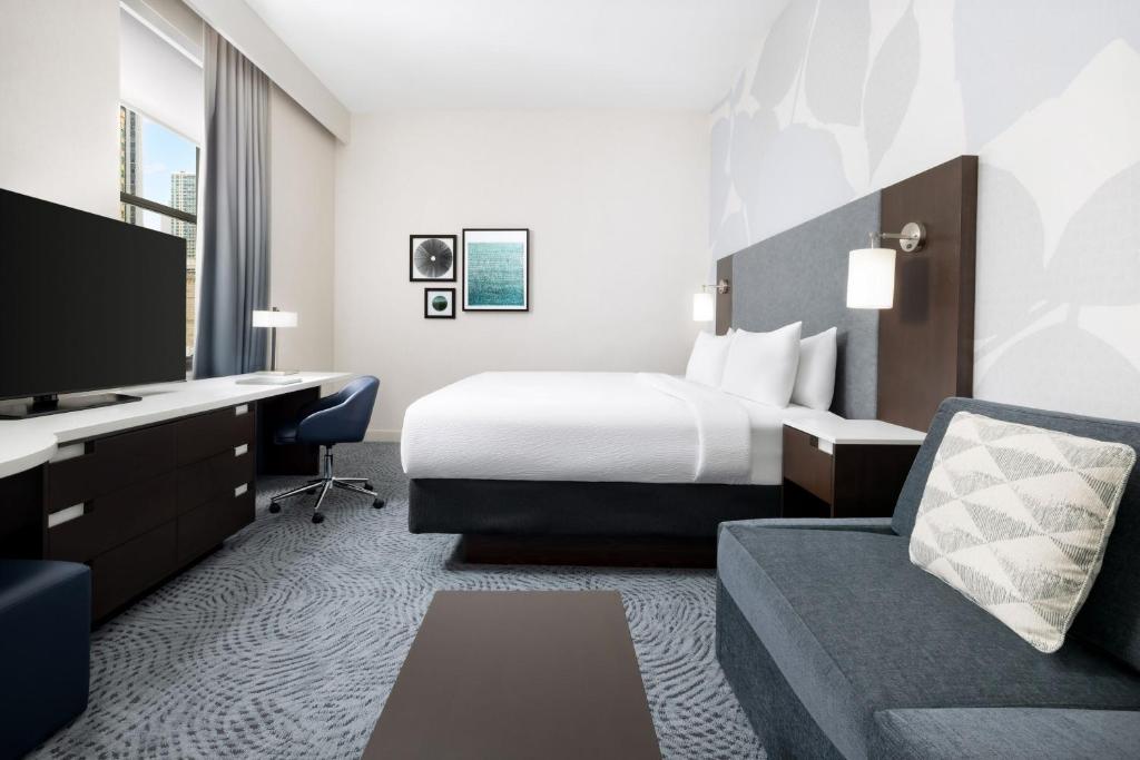 a hotel room with a bed and a desk at Residence Inn by Marriott New York Downtown Manhattan/World Trade Center Area in New York