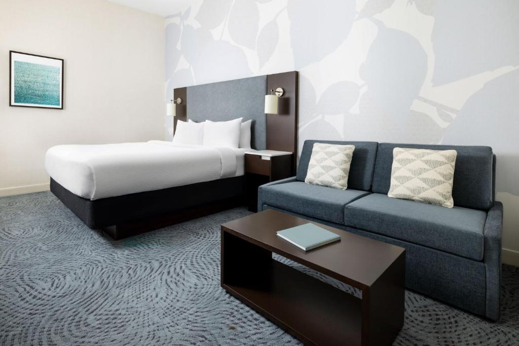 a hotel room with a bed and a couch at Residence Inn by Marriott New York Downtown Manhattan/World Trade Center Area in New York
