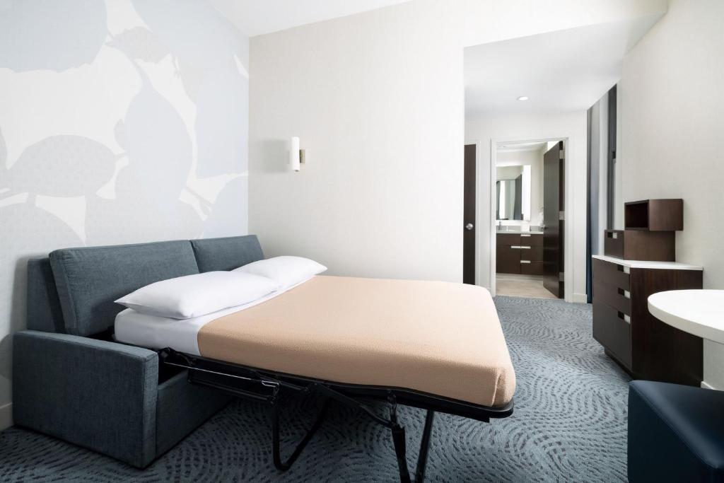 a room with a bed and a couch and a sink at Residence Inn by Marriott New York Downtown Manhattan/World Trade Center Area in New York