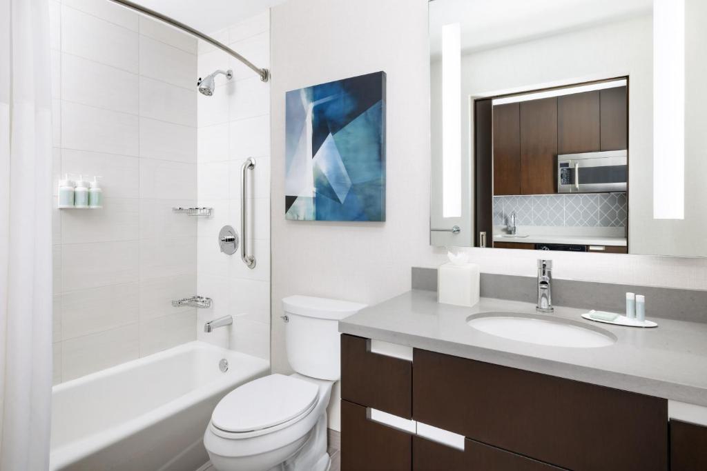 a white bathroom with a toilet and a sink at Residence Inn by Marriott New York Downtown Manhattan/World Trade Center Area in New York