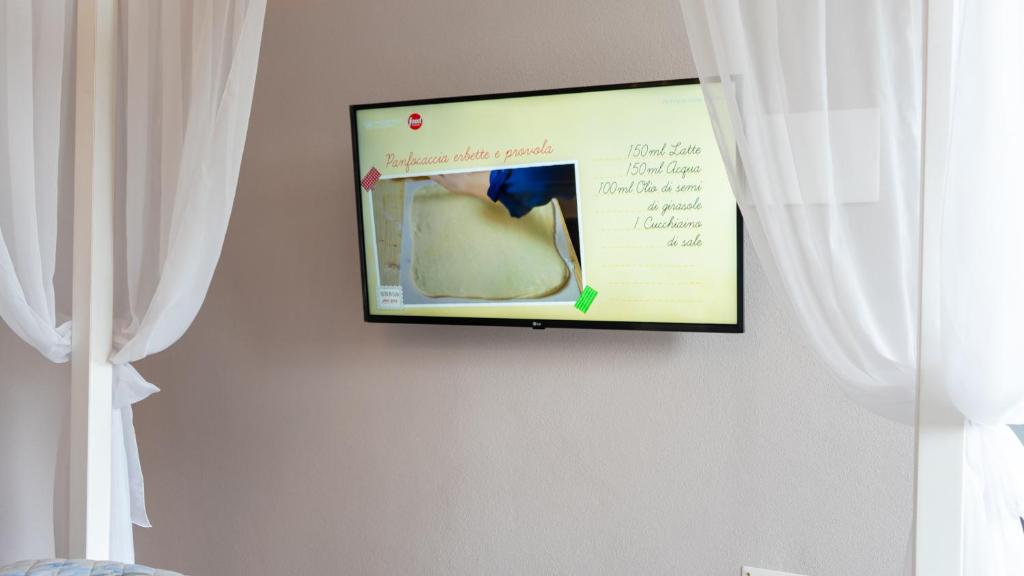 TV a/nebo společenská místnost v ubytování Giardini Malaspina