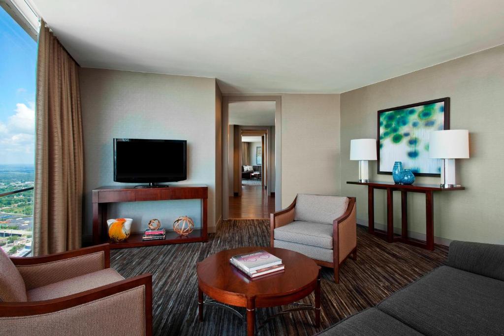 a living room with a couch and a tv at The Westin Peachtree Plaza, Atlanta in Atlanta