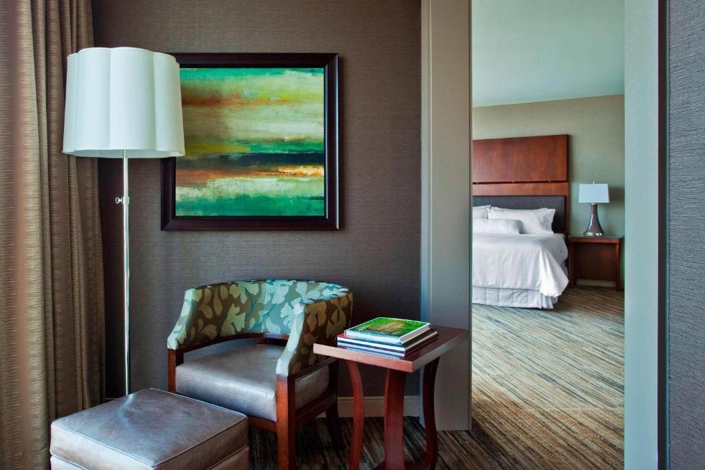a hotel room with a chair and a bed at The Westin Peachtree Plaza, Atlanta in Atlanta