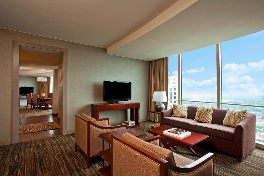 a living room with a couch and a tv at The Westin Peachtree Plaza, Atlanta in Atlanta