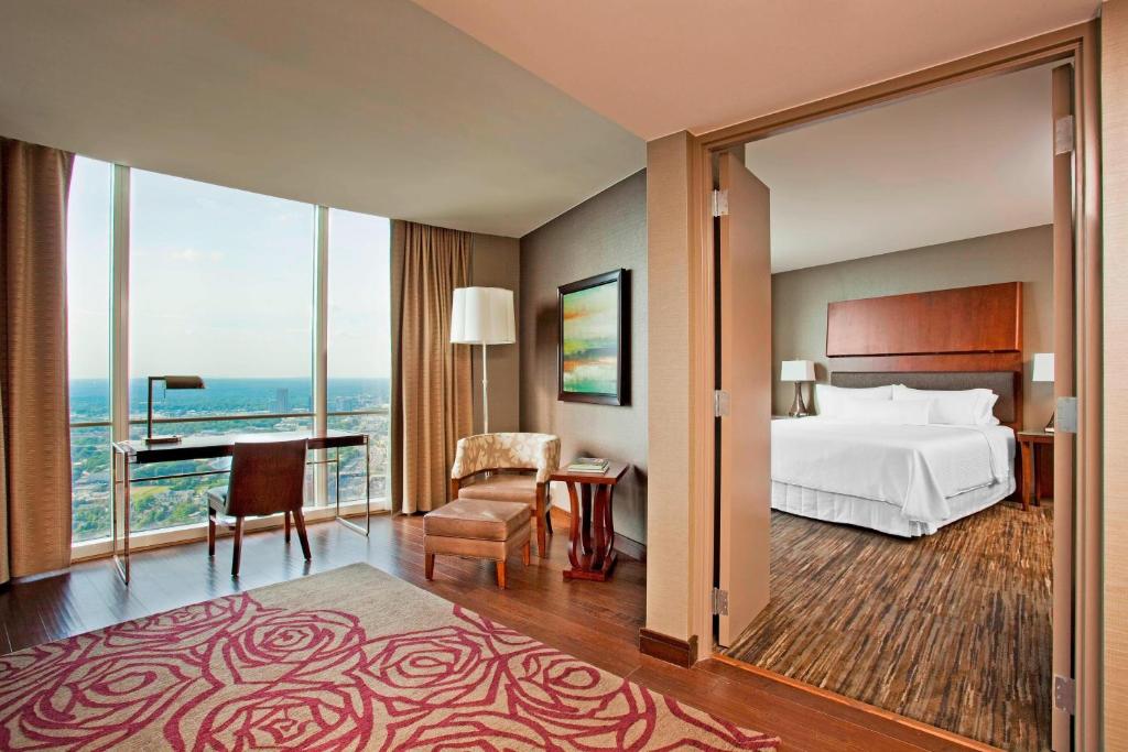 a hotel room with a bed and a desk at The Westin Peachtree Plaza, Atlanta in Atlanta