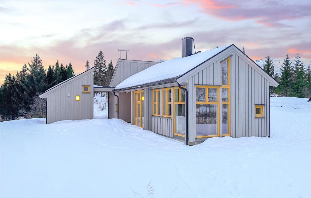 a small house in the snow in the winter at Amazing Home In Stamsund With Kitchen in Stamsund