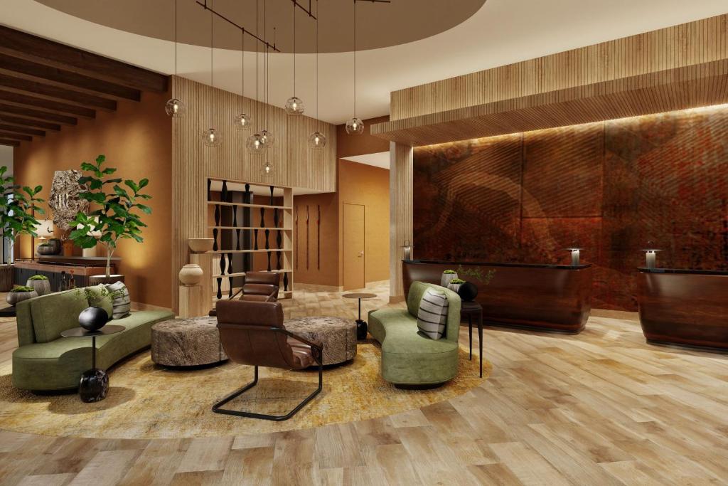 a lobby with a waiting area with green chairs and a waiting room at The Red Cliffs Lodge Zion, a Tribute Portfolio Hotel in Springdale