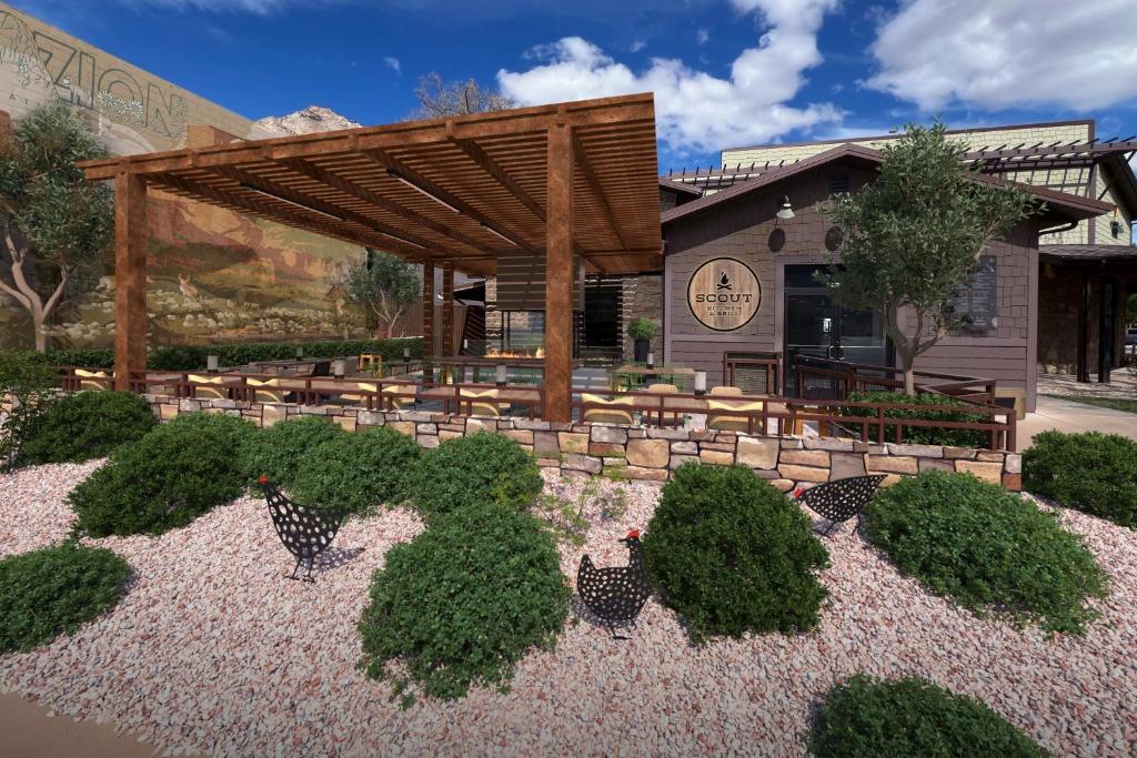 a garden with chickens in front of a building at The Red Cliffs Lodge Zion, a Tribute Portfolio Hotel in Springdale