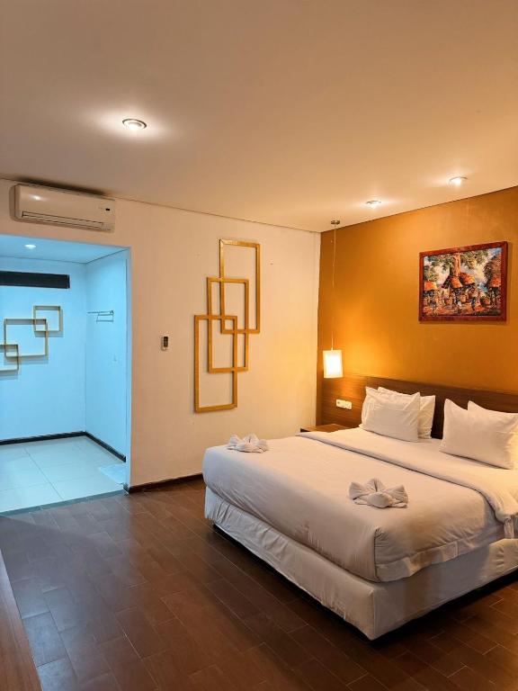 Postel nebo postele na pokoji v ubytování Hotel Ompu Herti