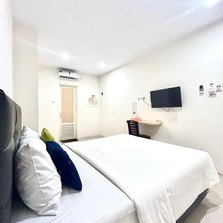 Letto o letti in una camera di Priority Guest House Samarinda