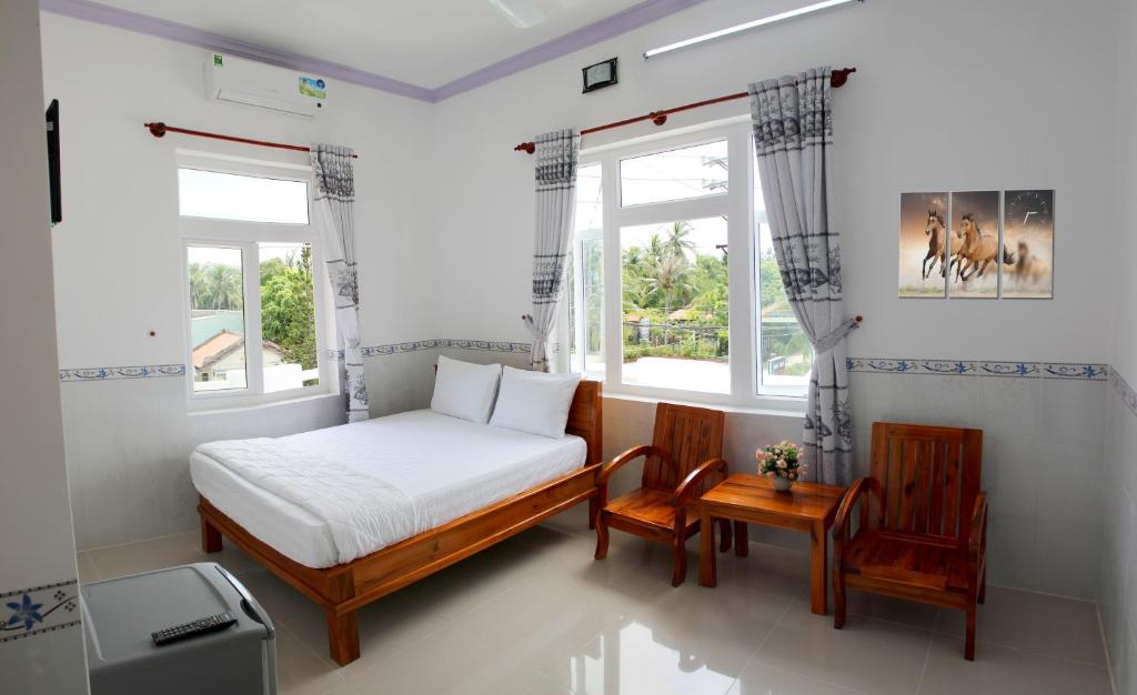Giường trong phòng chung tại Hung Phuc Mui Ne Hotel