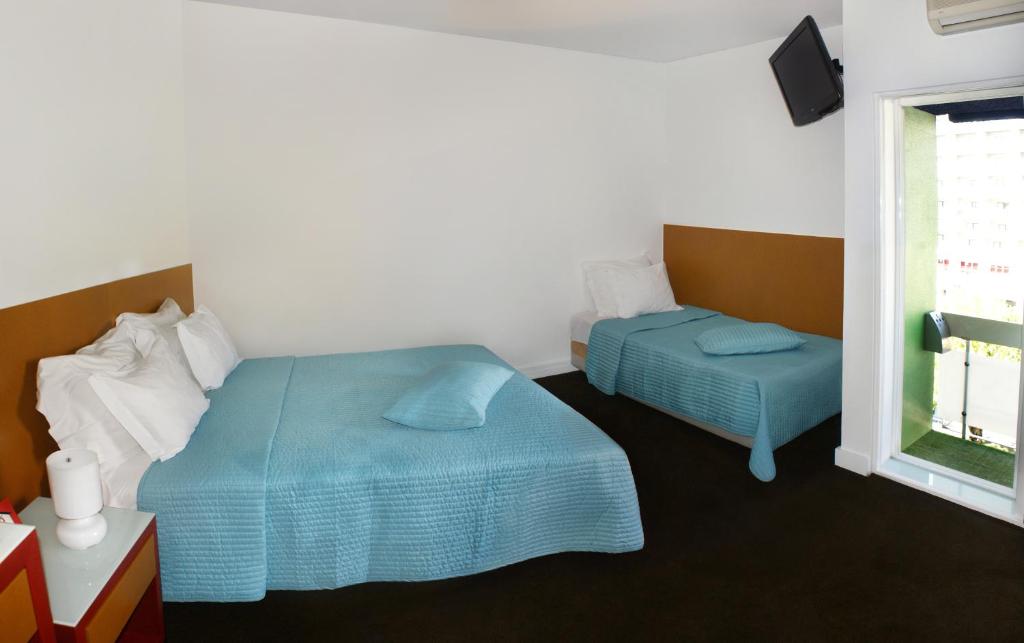 Postel nebo postele na pokoji v ubytování Hotel Joao XXI