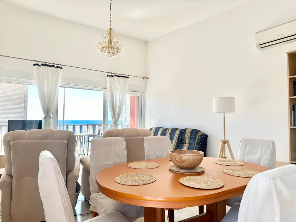 a dining room with a wooden table and chairs at Apartment Elaine's View in Umag