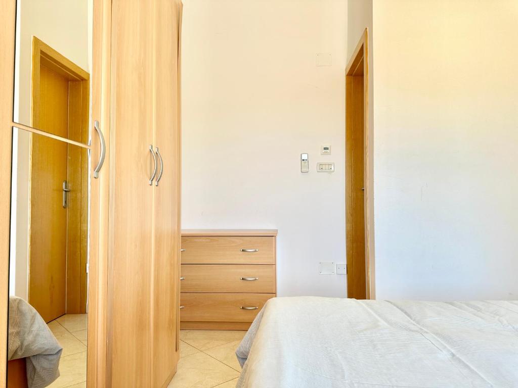 a bedroom with a bed and a dresser at Apartment Elaine's View in Umag
