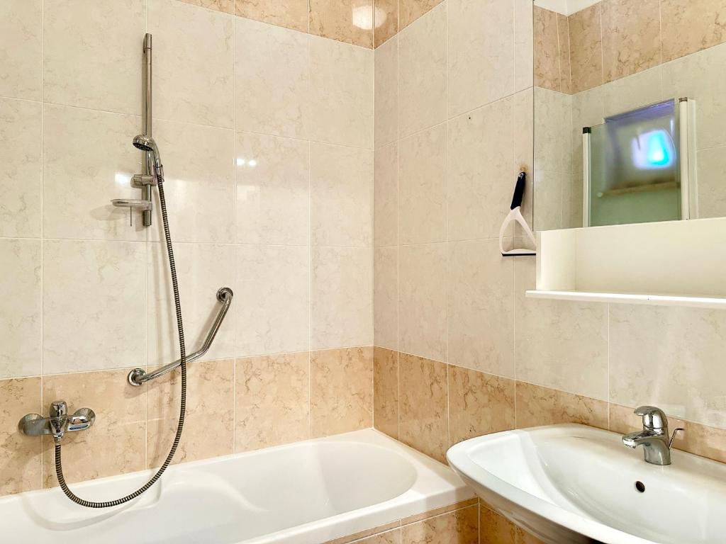 a bathroom with a shower and a tub and a sink at Apartment Elaine's View in Umag