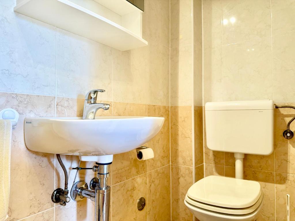 a bathroom with a sink and a toilet at Apartment Elaine's View in Umag