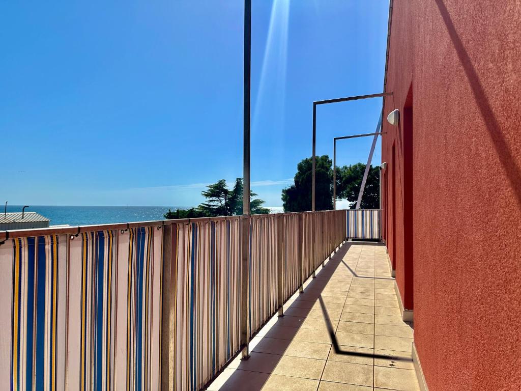 a fence on the side of a building next to the ocean at Apartment Elaine's View in Umag