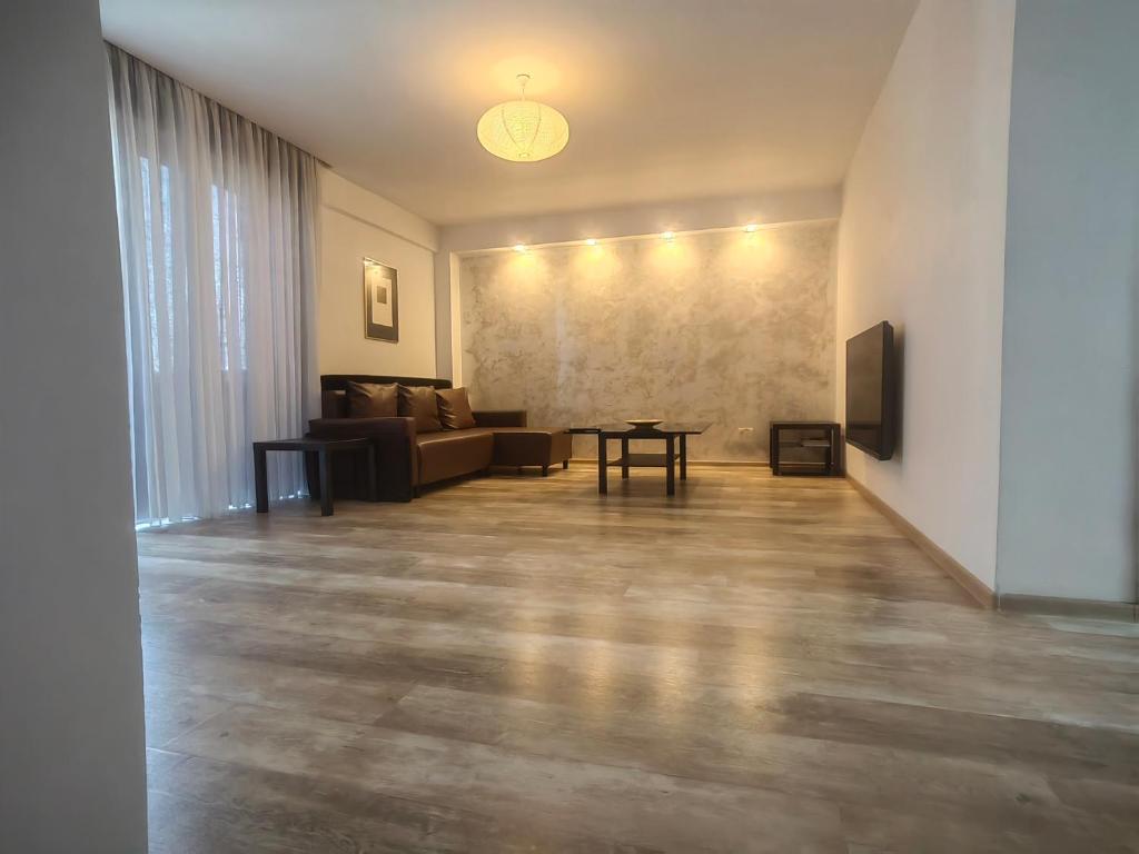 a living room with a couch and a table at 4 RENT - Apt 3 camere in Constanţa