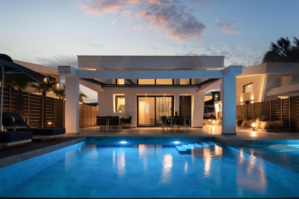 a house with a swimming pool in front of it at MySarti Villas in Sarti