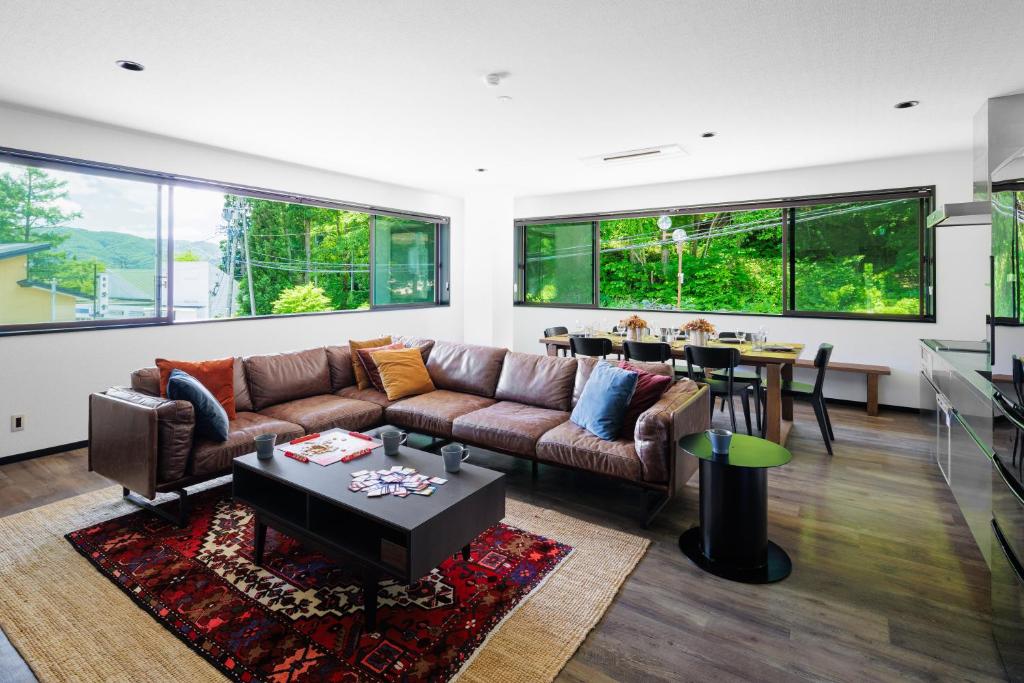 a living room with a couch and a table at Happo Apartments by HHG in Hakuba