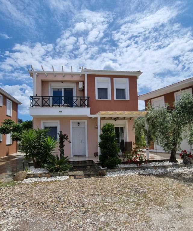 a large house with a yard in front of it at Oikies in Prinos