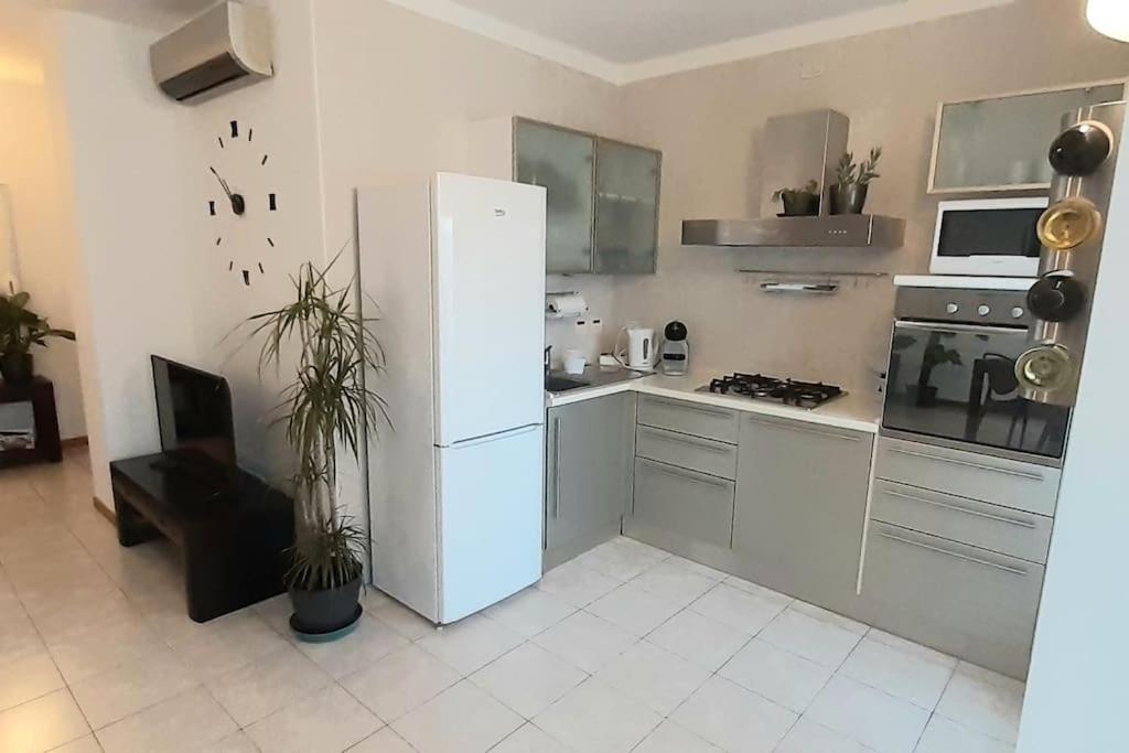 a kitchen with a white refrigerator and a stove at Casa Olimpia 52 in Verona