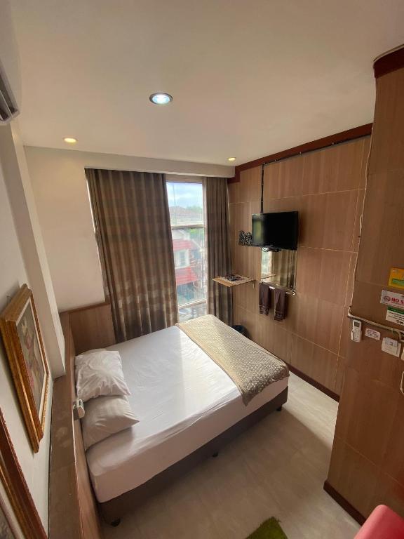 Postel nebo postele na pokoji v ubytování The Cabin Hotel Gandekan