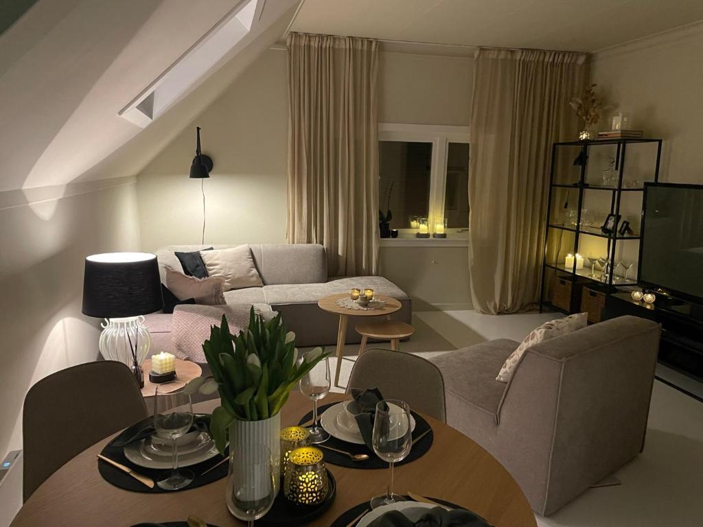 a living room with a couch and a table at High rated private appartment 350 m from Ålesund center with free parking in Ålesund