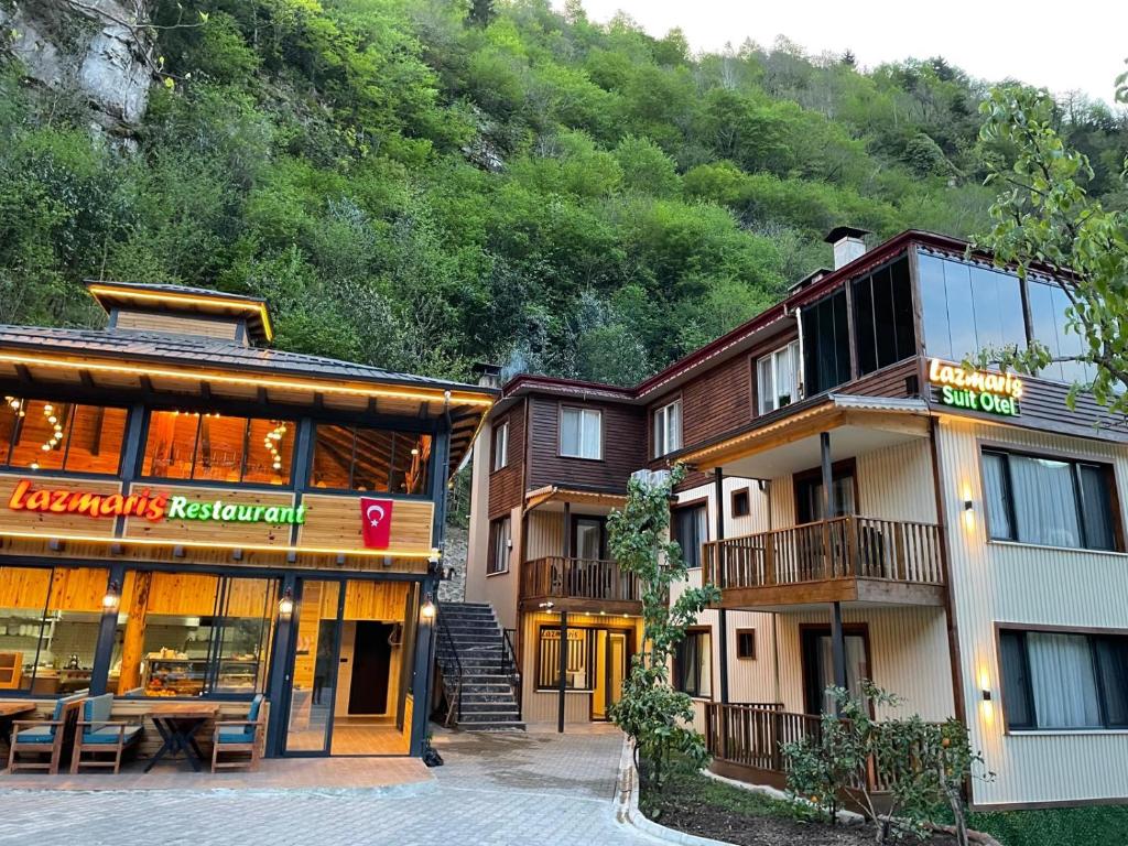 a hotel with a mountain in the background at Lazmaris Suit in Çamlıhemşin