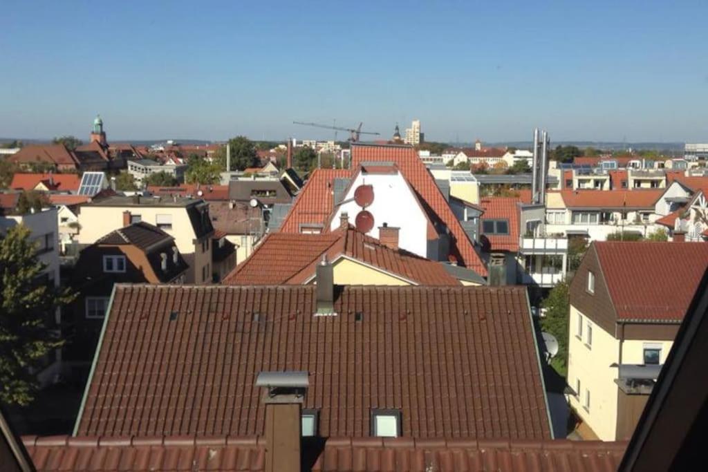 a view of roofs of buildings in a city at Charmantes Dachloft mit spektakulärer Aussicht in Ludwigsburg