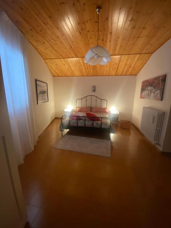 a bedroom with a bed and a wooden ceiling at La Casa di Rita in Fogliano