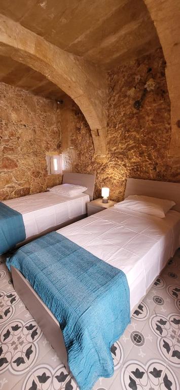Postel nebo postele na pokoji v ubytování Tan-Napli Farmhouse