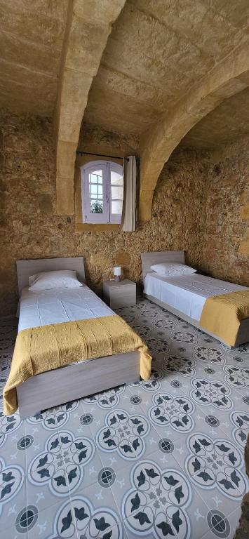 Postel nebo postele na pokoji v ubytování Tan-Napli Farmhouse