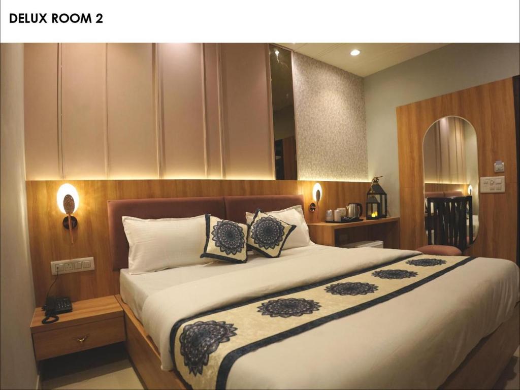 a bedroom with a large bed with two pillows at Narison by Divud Ecom in Amritsar