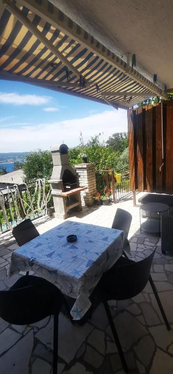 a table and chairs on a patio with a view at Apartment Eden in Crikvenica
