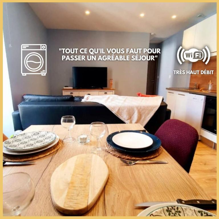 une table en bois avec des assiettes et des verres à vin dessus dans l'établissement ღ L'Ecluse - Centre ville, Wifi fibre, Netflix, à Béziers