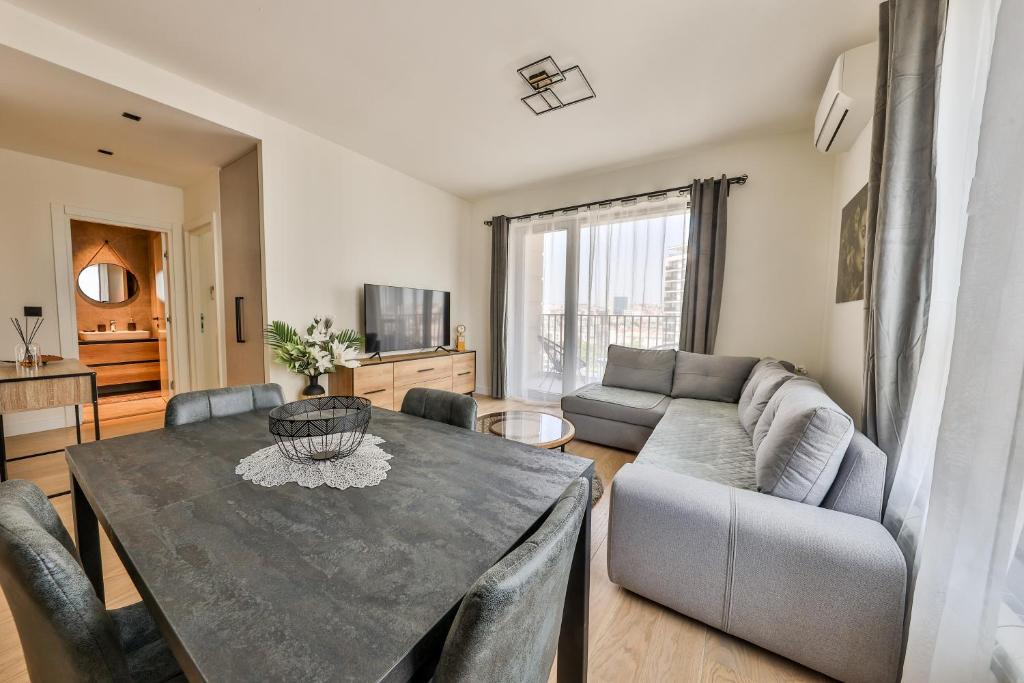 a living room with a table and a couch at Modern apartment on the Belgrade Waterfront in Belgrade