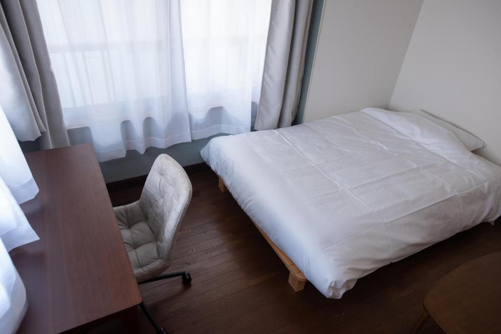 Postel nebo postele na pokoji v ubytování 富江宿