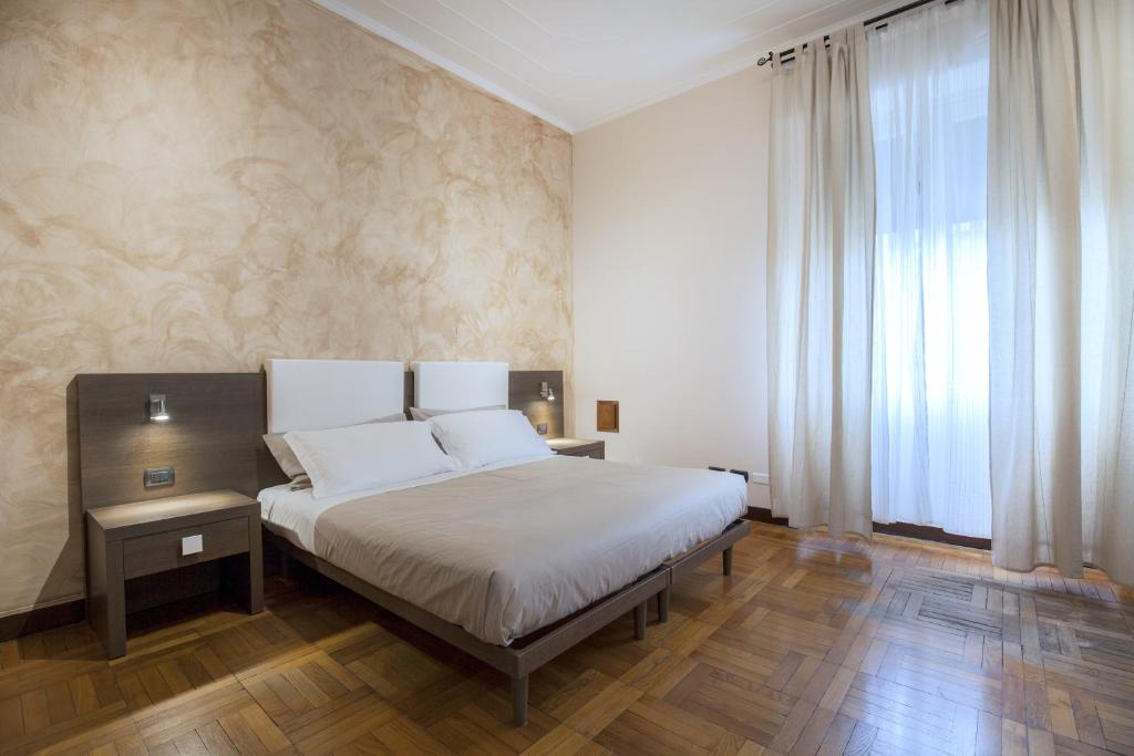 Postel nebo postele na pokoji v ubytování Guesthouse Vittoria Rooms - the Original since 2015