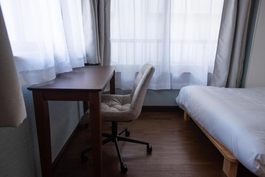 Postel nebo postele na pokoji v ubytování 富江宿