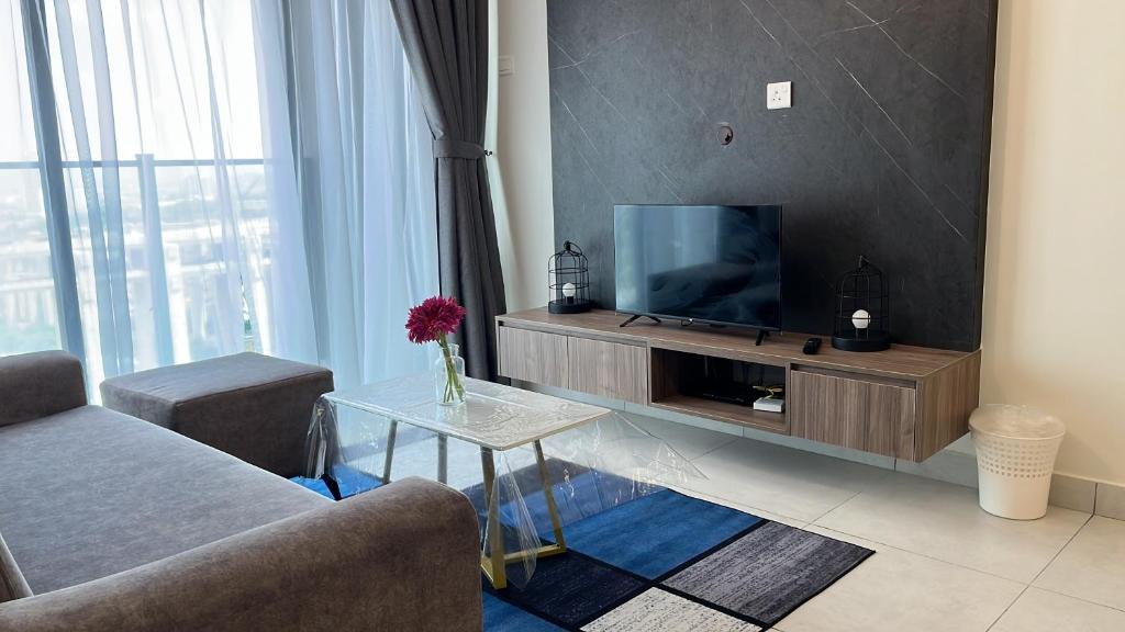a living room with a tv and a couch and a table at Majestic maxim 3BR luxury family house MRT kuala lumpur in Kuala Lumpur